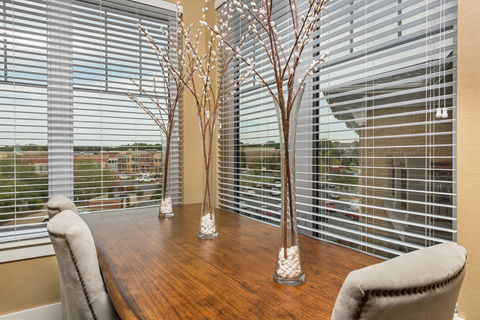 A dining room with a wooden table and chairs.