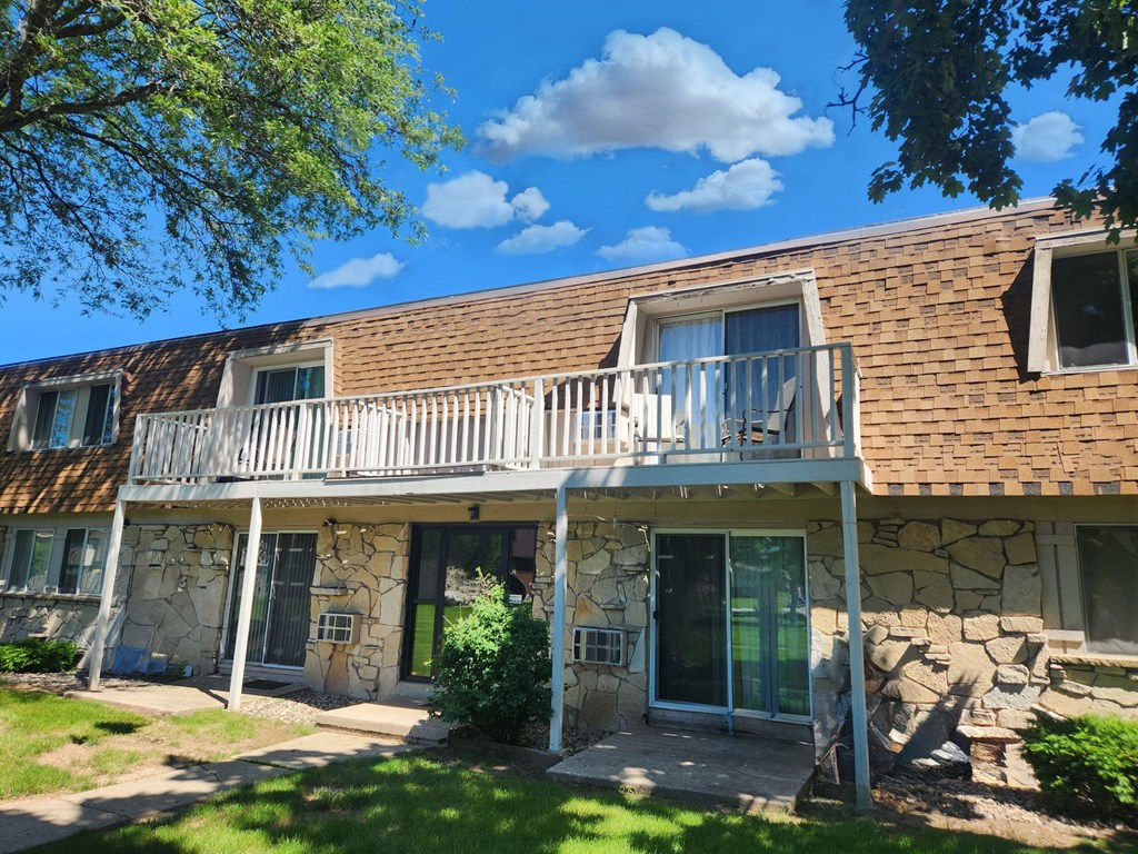 the front of a stone house with a balcony