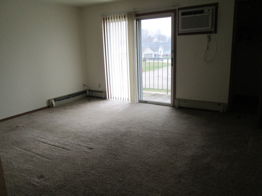 an empty room with a sliding glass door