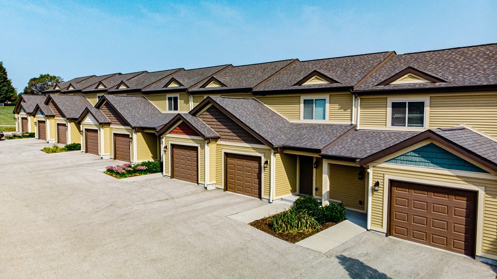 A row of houses with brown garage doors.