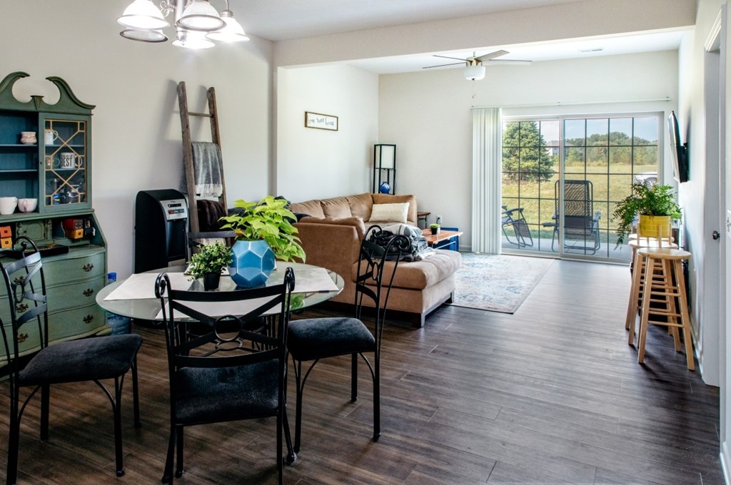 A living room with a white table and chairs.