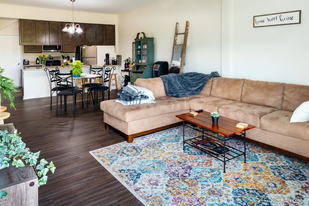 A living room with a couch, chairs, and a coffee table.