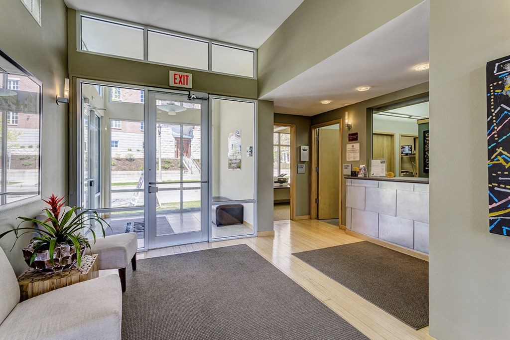 a lobby with a reception area and glass doors