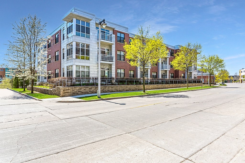 an empty street in front of an apartment building