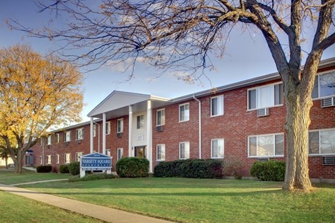 A brick apartment building with a sign in front that says "Bethesda".