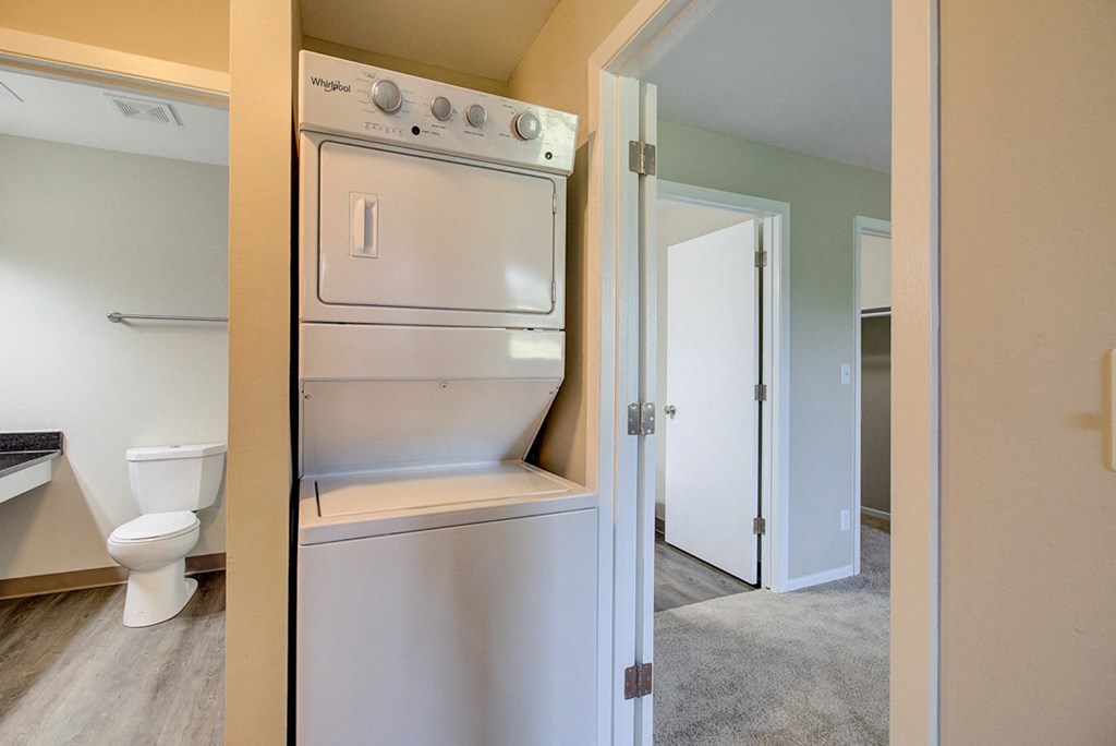 an empty laundry room with a washer and dryer