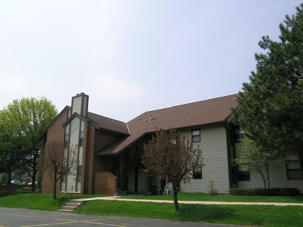 a church building with a brown roof and white walls