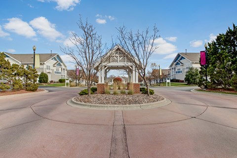 A gazebo is surrounded by a circular driveway.