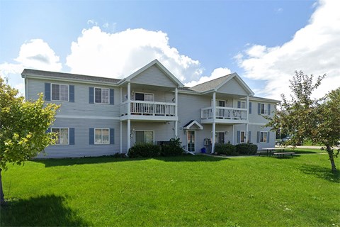 A large two-story house with a balcony on the second floor.
