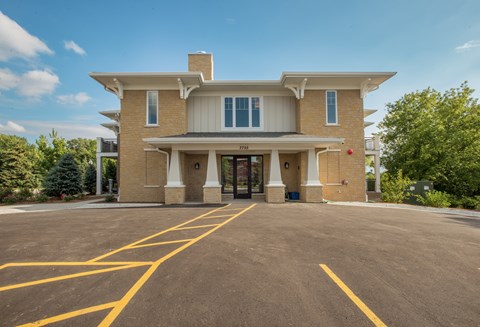 A large building with a parking lot in front of it.