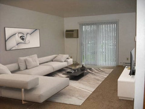 a living room with two white couches and a television