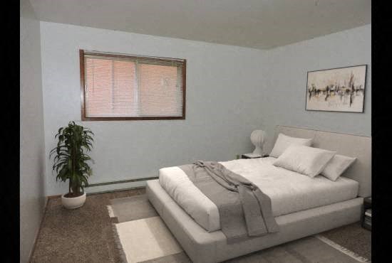 a white bedroom with a bed and a plant