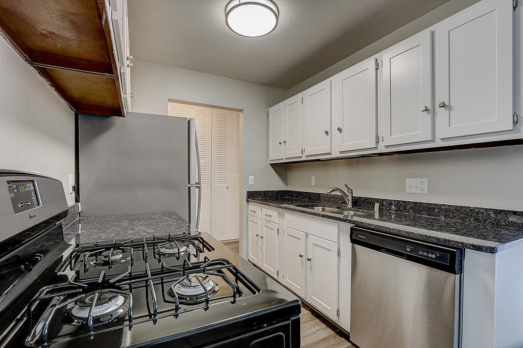 a kitchen with a stove and a refrigerator
