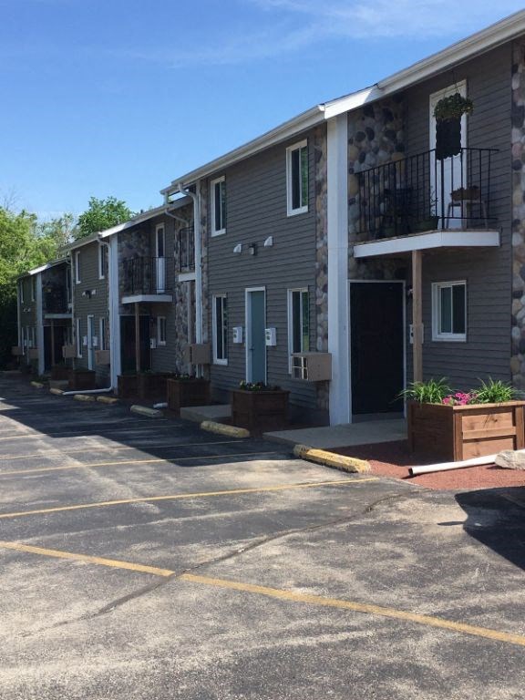an empty parking lot in front of an apartment building
