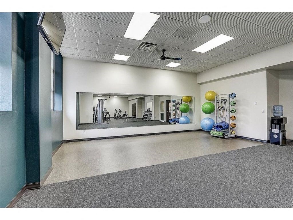 an empty room with a mirror and balloons in it