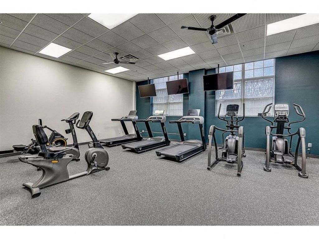 a gym with treadmills and other exercise equipment