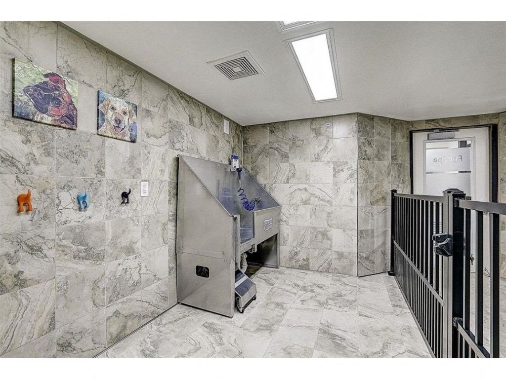 the elevator in the lobby of a building with marble walls