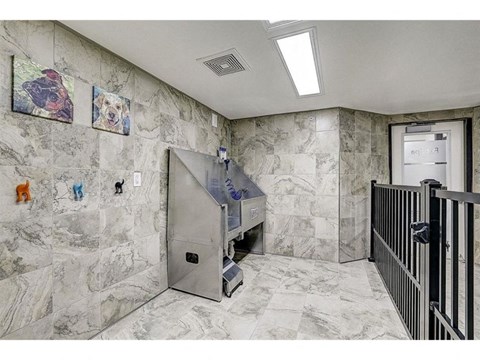 the elevator in the lobby of a building with marble walls