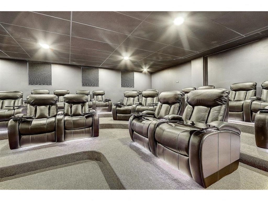 a large auditorium filled with chairs and a projector screen