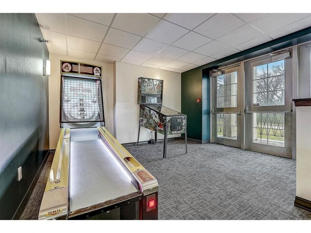 a game room with a ping pong table and a window