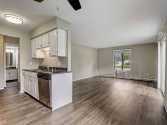an empty kitchen and living room with an open floor plan