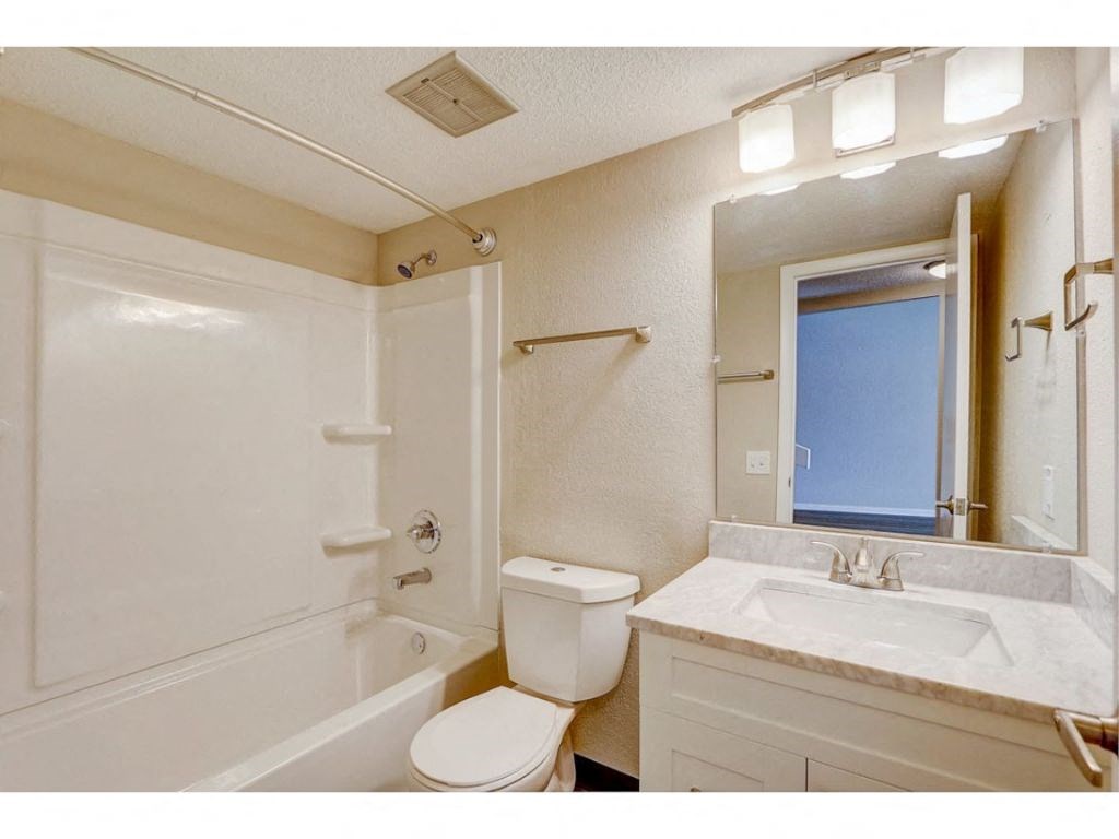 a bathroom with a sink toilet and a tub