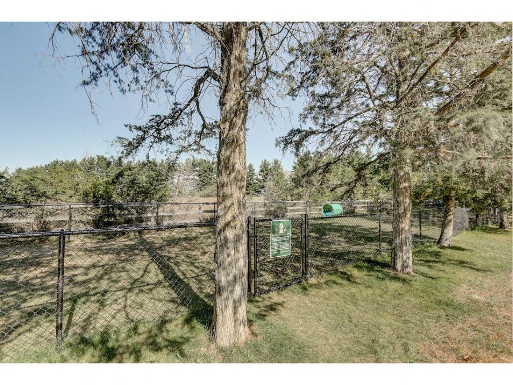 a fenced in area with trees and a fence