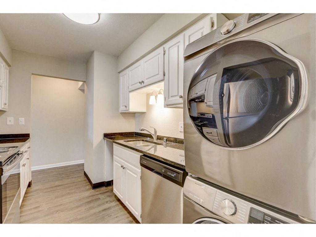 a kitchen with a washer and dryer and a sink