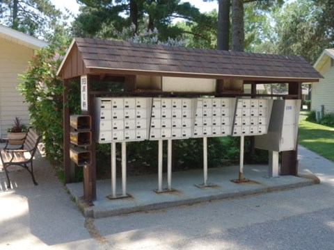 a public urinal with a roof and a traffic light