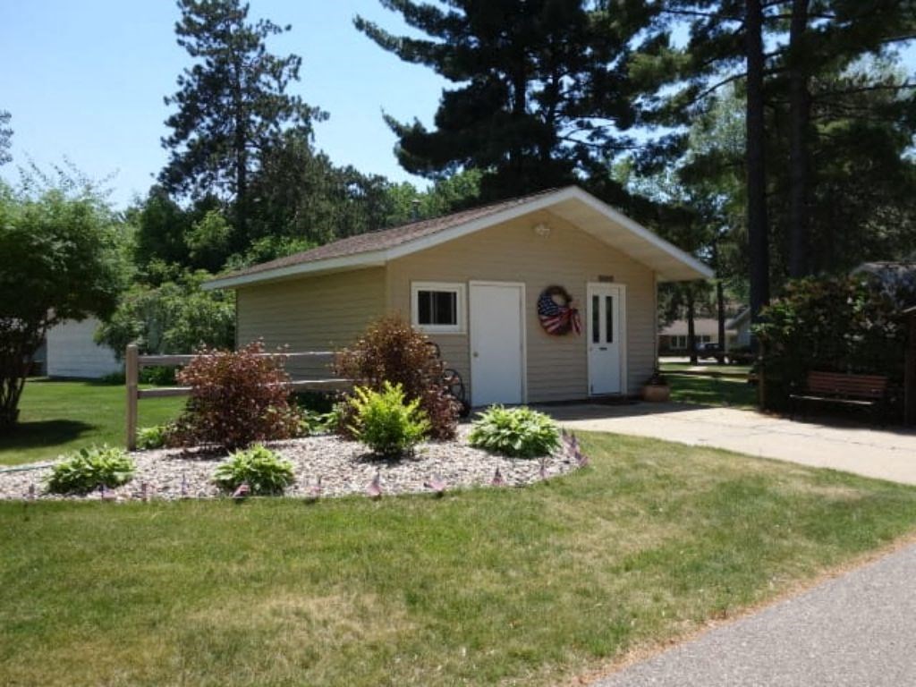 a small yellow house with a garden in front of it