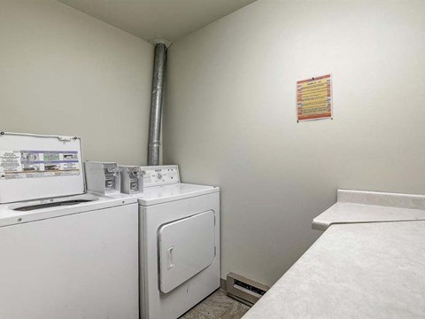 a laundry room with a washer and a dryer in it
