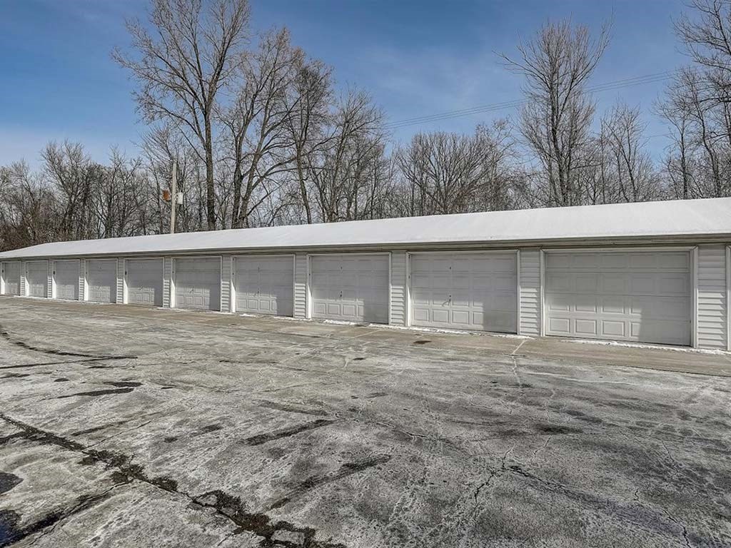 a building with white doors and a parking lot
