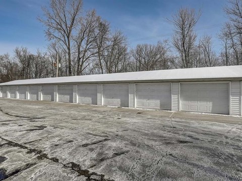 a building with white doors and a parking lot