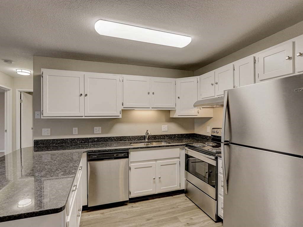 a kitchen with stainless steel appliances and white cabinets