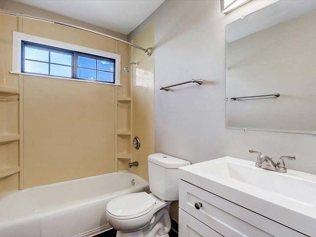 a bathroom with a sink toilet and a bath tub
