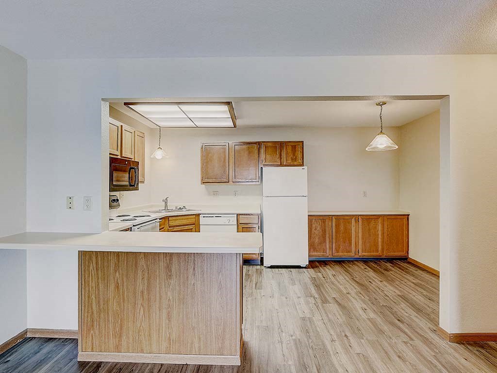 a kitchen with a white refrigerator and a counter top