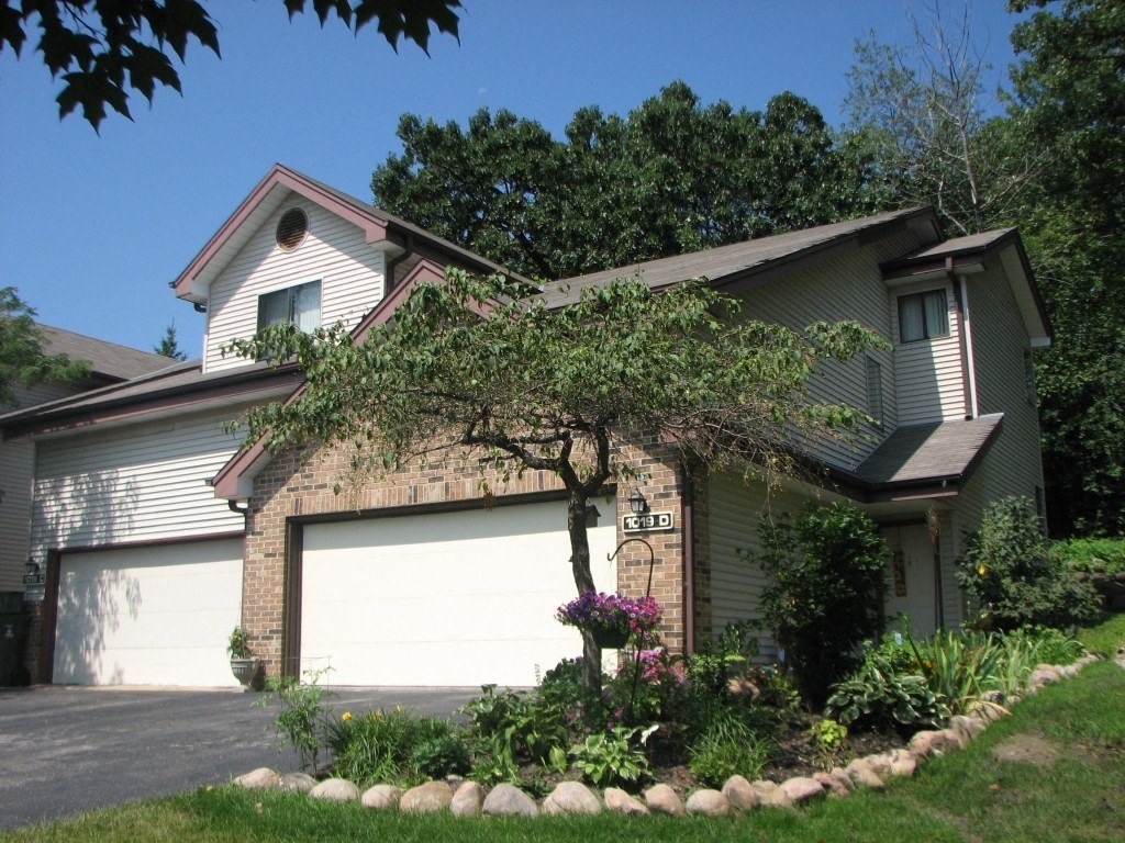 a house with a white garage door in front of it