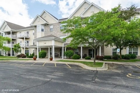 A large building with a parking lot in front of it.