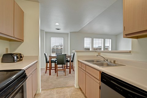 A kitchen with a table and chairs in the middle of the room.