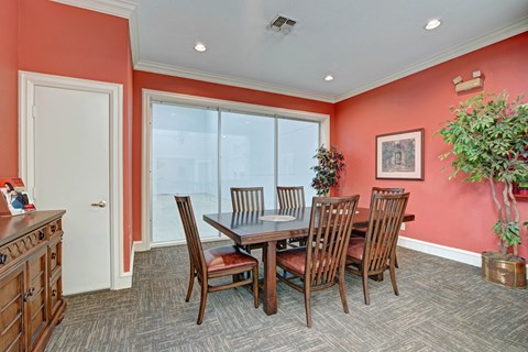 A dining room with a table and chairs.