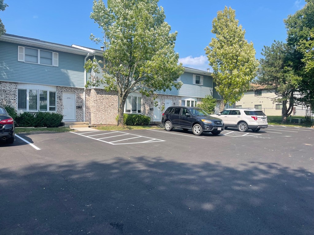 a parking lot in front of an apartment building