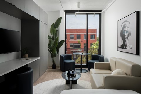 a living room with white furniture and a large window