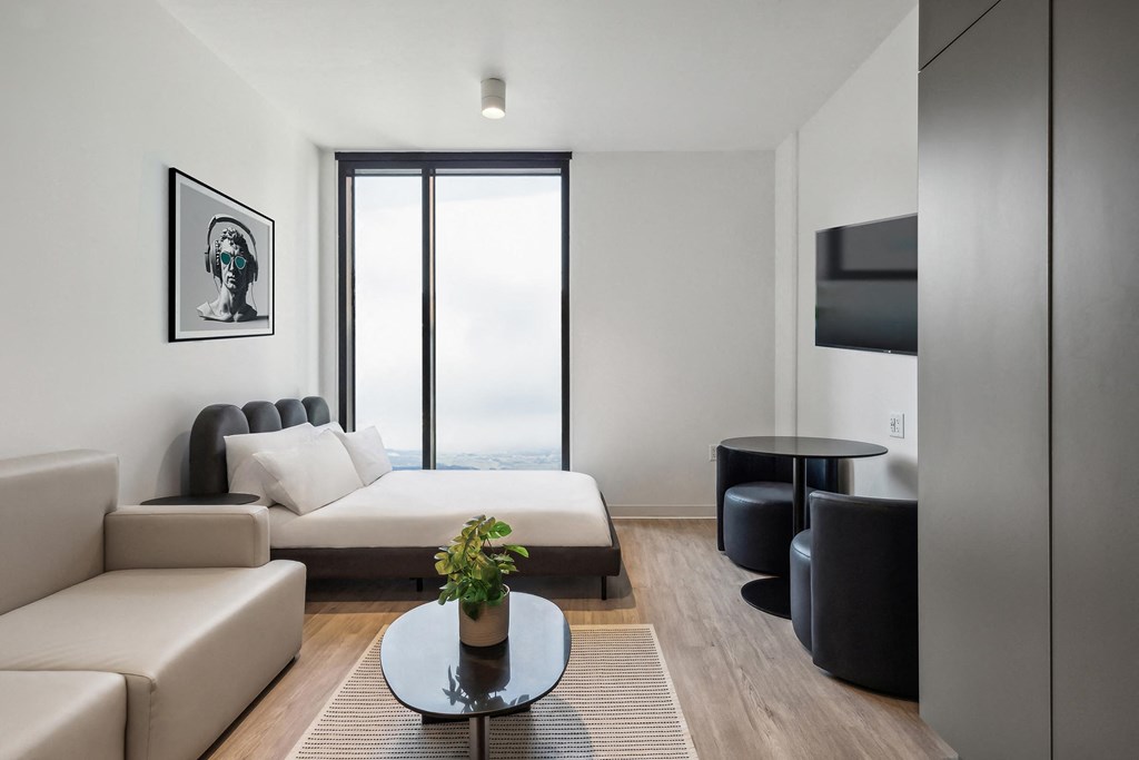 a bedroom with a bed and a couch and a table