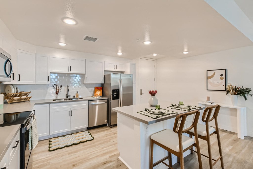 a kitchen with white cabinetry and stainless steel appliances at The Venue at Orange Apartments, Redlands, 92373