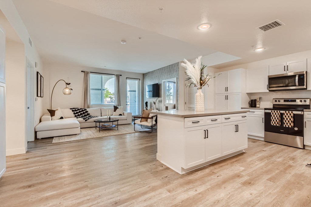 a kitchen and living room with hardwood floors at The Venue at Orange Apartments, California, 92373