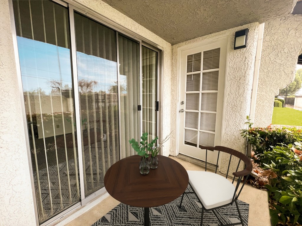 a patio with a table and chairs on a balcony