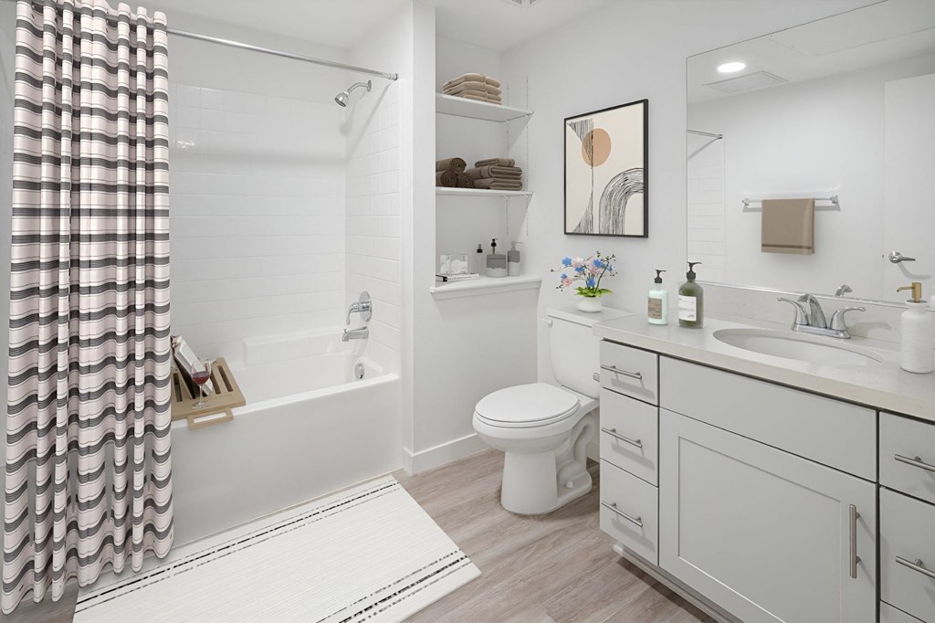 a bathroom with a shower and a toilet and a sink