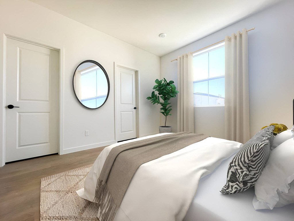 a white bedroom with a white bed and a potted plant at The Willow Townhomes, Ontario, CA