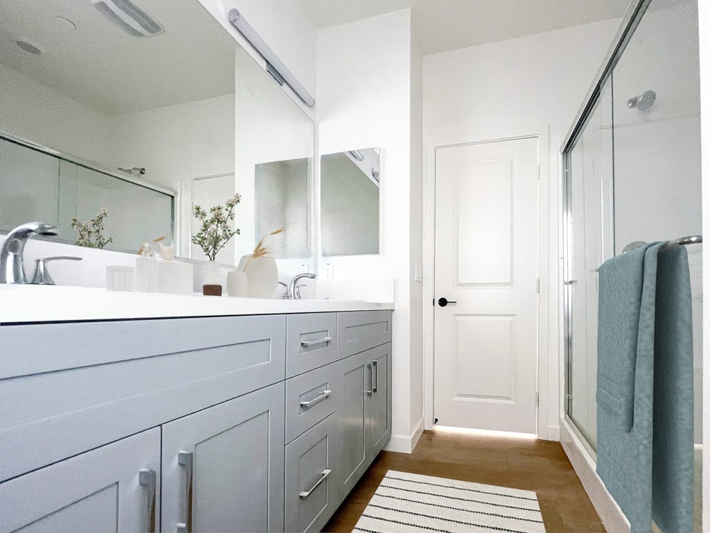 a white bathroom with a sink and a shower at The Willow Townhomes, CA 91762