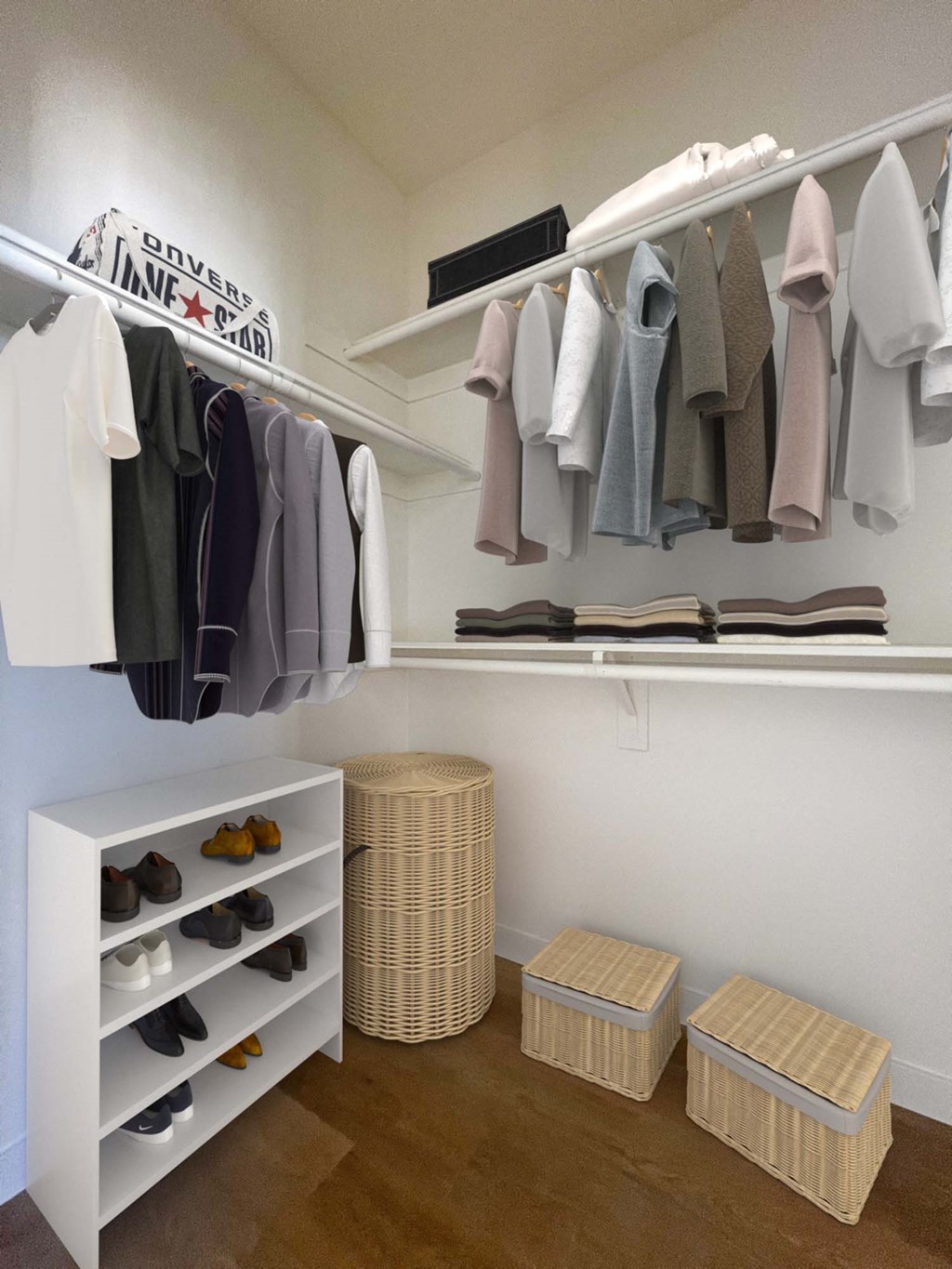 a walk in closet with a rack of clothes and baskets at The Willow Townhomes, Ontario
